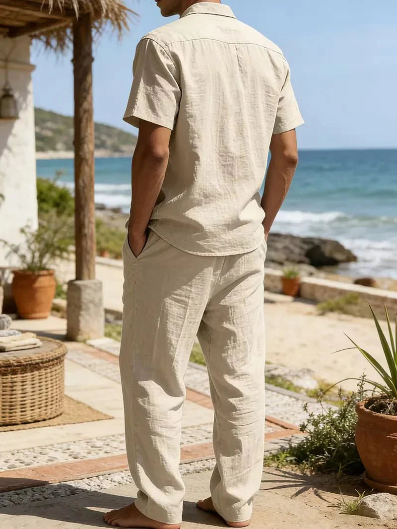  Man displaying a relaxed travel-ready outfit on a plain background.
