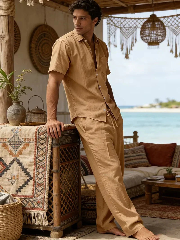  Male model wearing a casual matching set with trousers on a plain background.