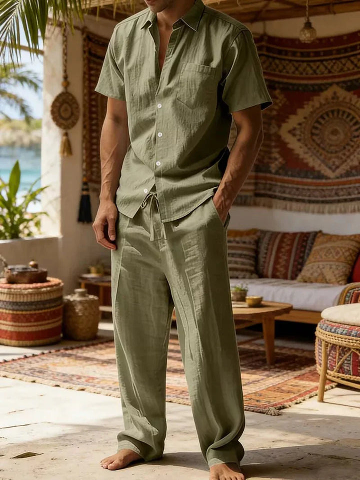  Man showcasing a coordinated leisure look on a plain background.