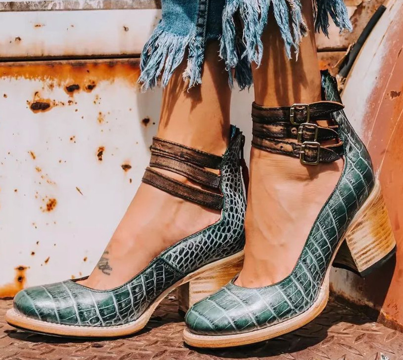  Model presenting modern sandals against a plain background.
