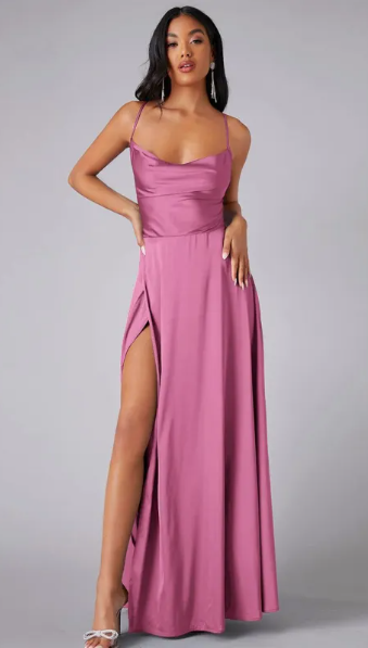 Woman in a satin evening outfit featuring a lace-up back detail on a plain background.