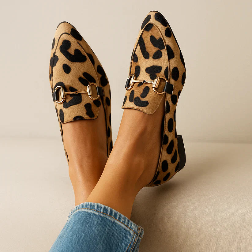 Woman model wearing leopard loafers, front view, plain background, pose.