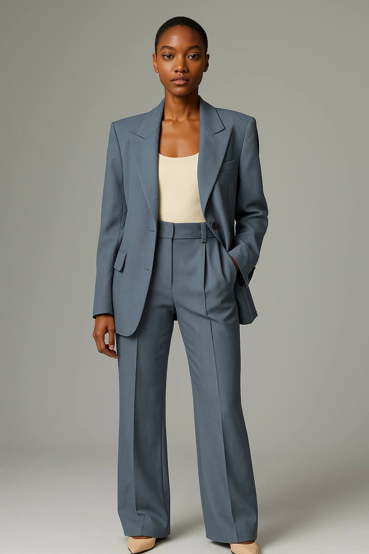 Model in a refined two piece outfit with a fitted jacket and straight trousers.