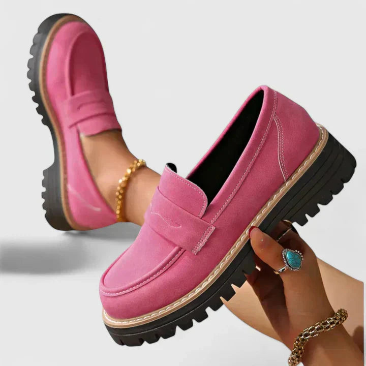 Pair of pink shoes styled on white backdrop