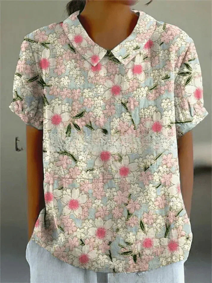 Female model in a soft floral blouse with a clean background.