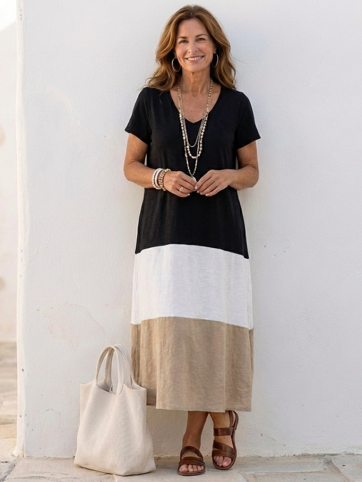 Female wearing a color block midi dress with short sleeves against a plain background.