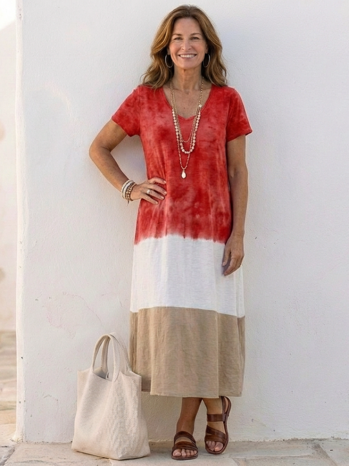 Female model in a relaxed-fit color block dress with midi length on a plain background.