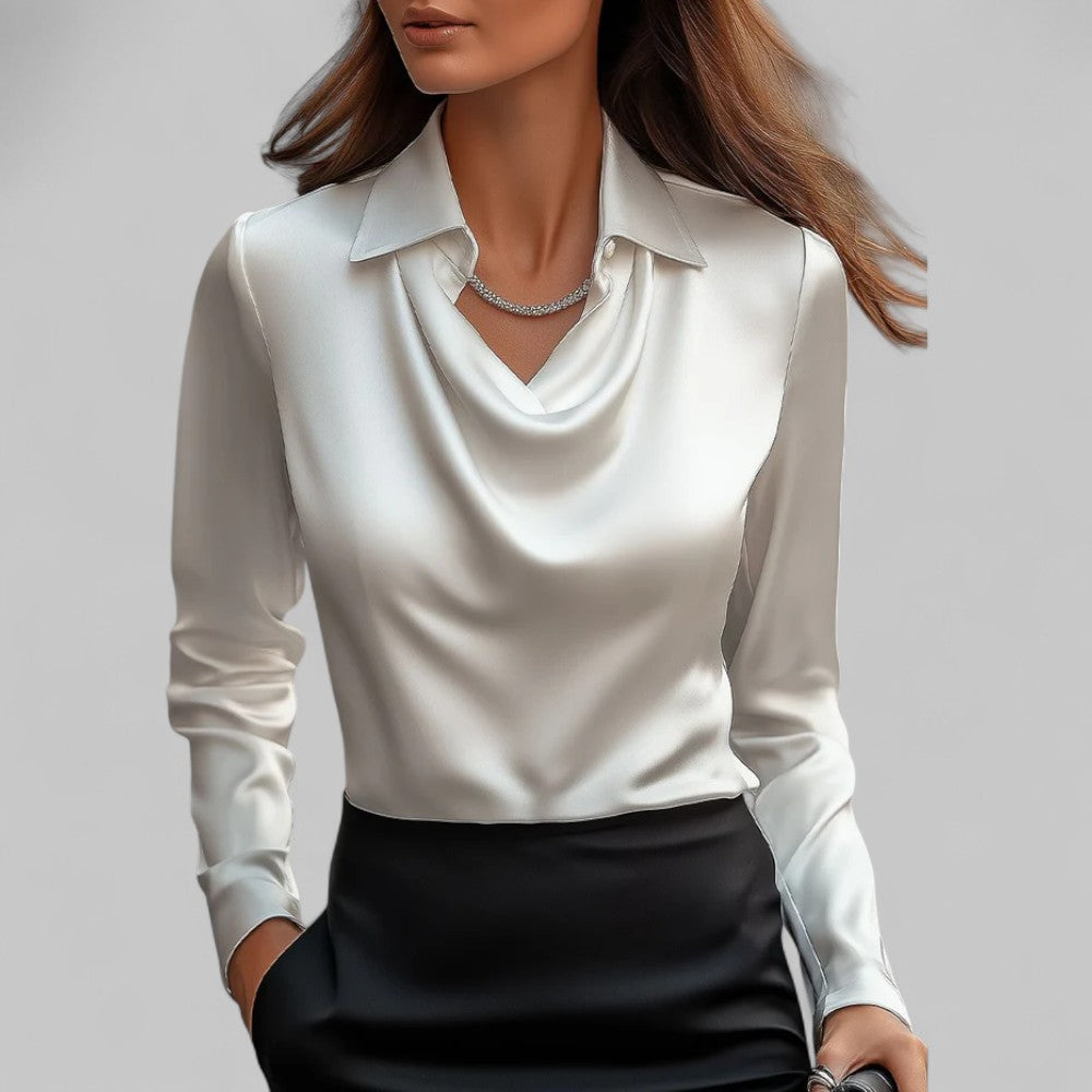 Woman model wearing an elegant long sleeve satin blouse on a plain background.