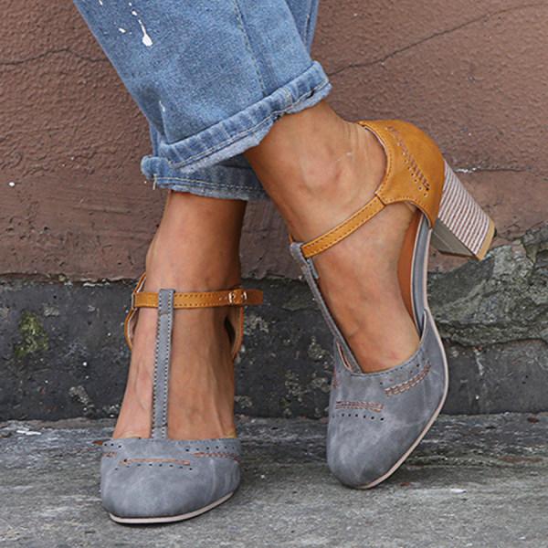 Woman wearing closed-toe heeled sandals on wall background elegantly.
