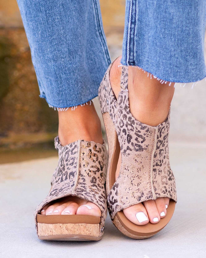 Front view foot wearing hiking sandals on gray floor background