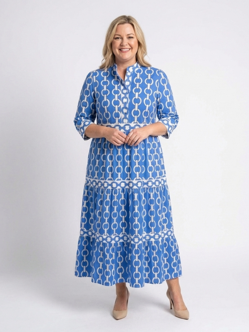 Woman showcasing a flowing chain print midi dress with 3/4 sleeves.
