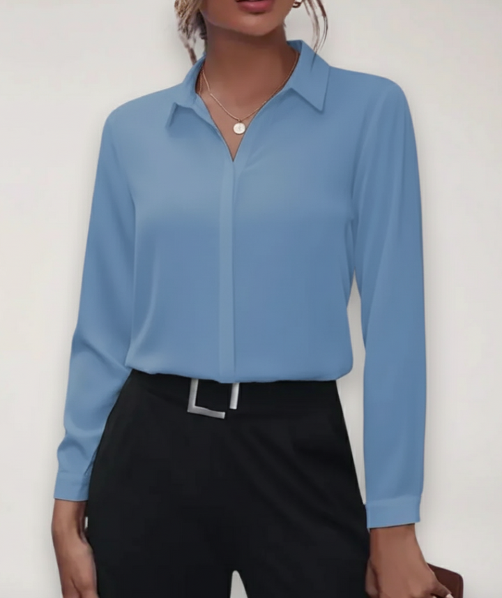 Model in lightweight button-up blouse with smooth seams and a professional warm-weather look.