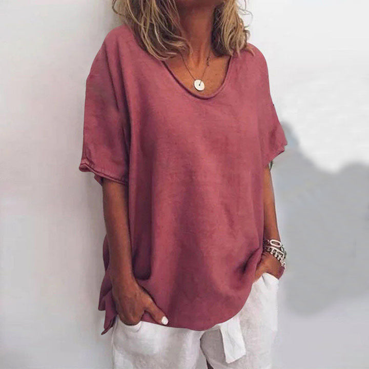 Woman posing in lightweight blouse on plain background