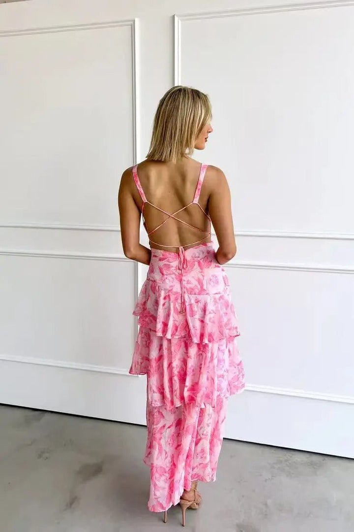 Model standing straight wearing layered floral maxi plain background,  back view