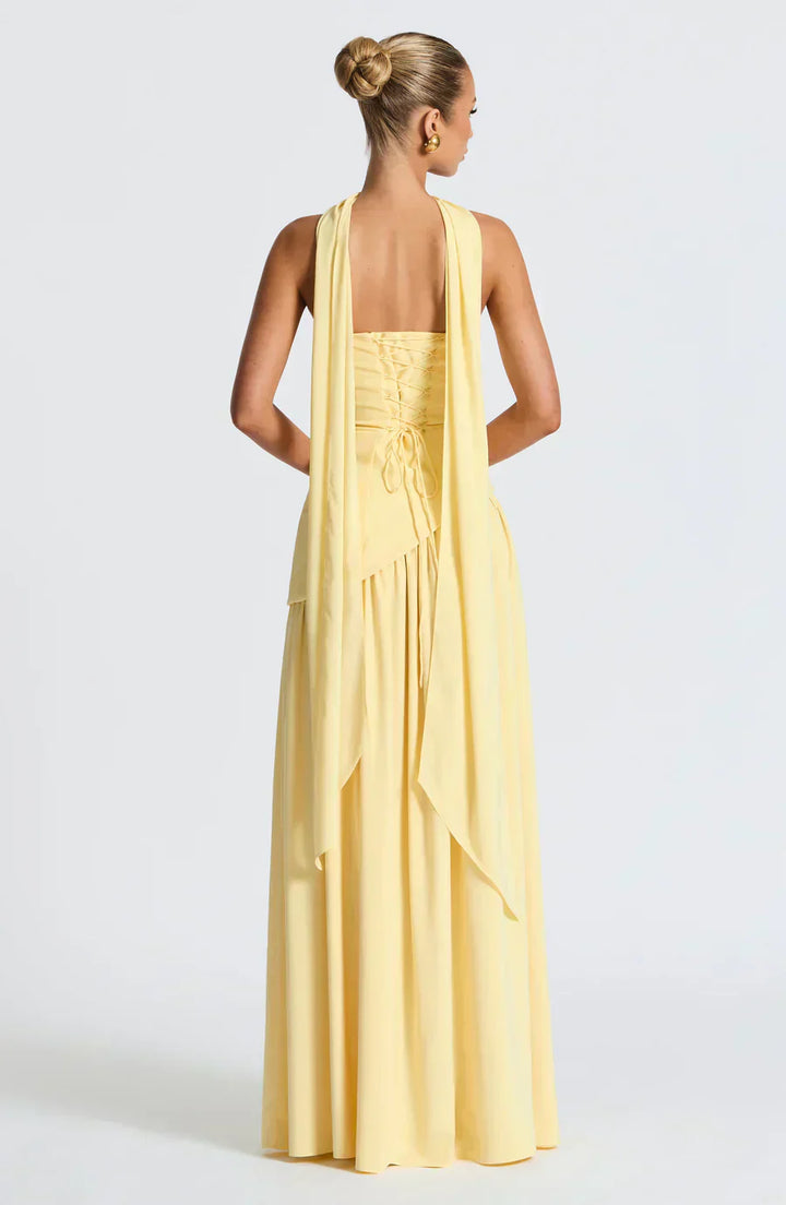 Model showing graceful long dress silhouette on plain background., back view