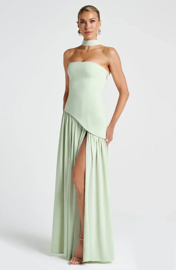 Model displaying asymmetric maxi style on plain background, front view.