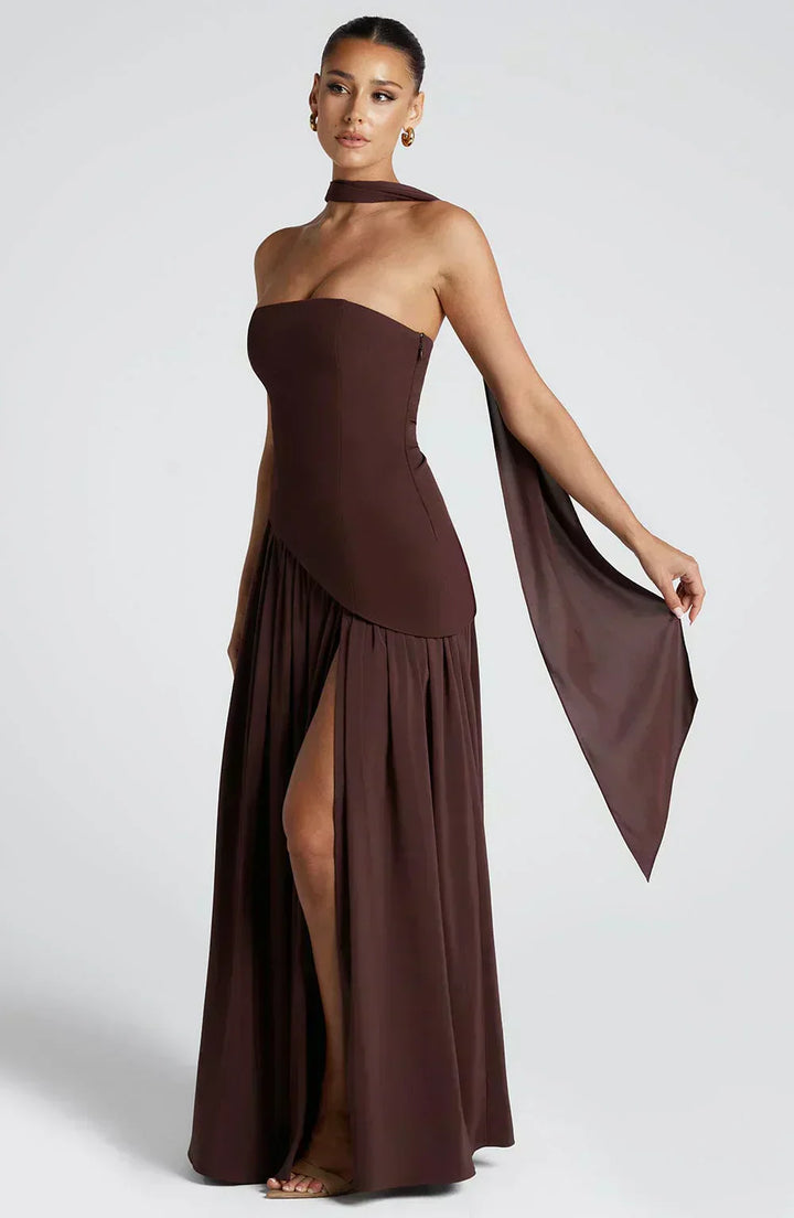 Female model in a one-shoulder dress with a graceful flowing silhouette.