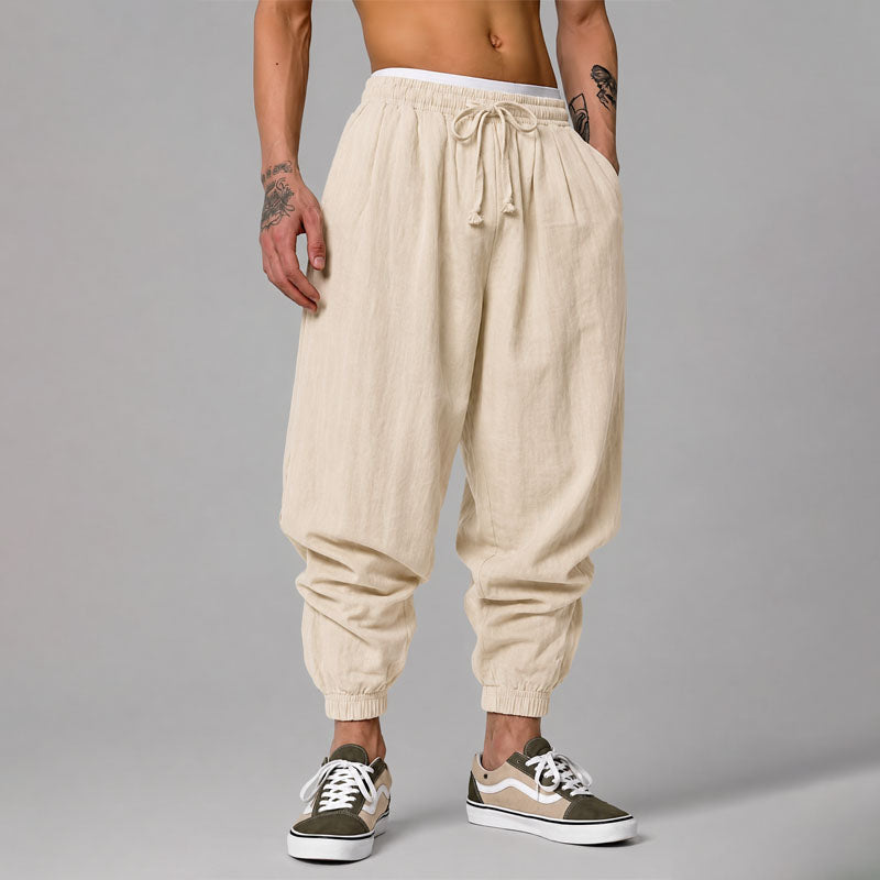Model wearing relaxed tapered jogger pants against a plain background.