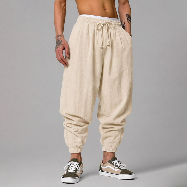 Model wearing relaxed tapered jogger pants against a plain background.