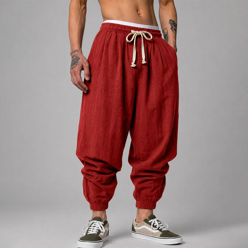  Female model wearing lightweight jogger pants with a drawstring waist on a plain background.