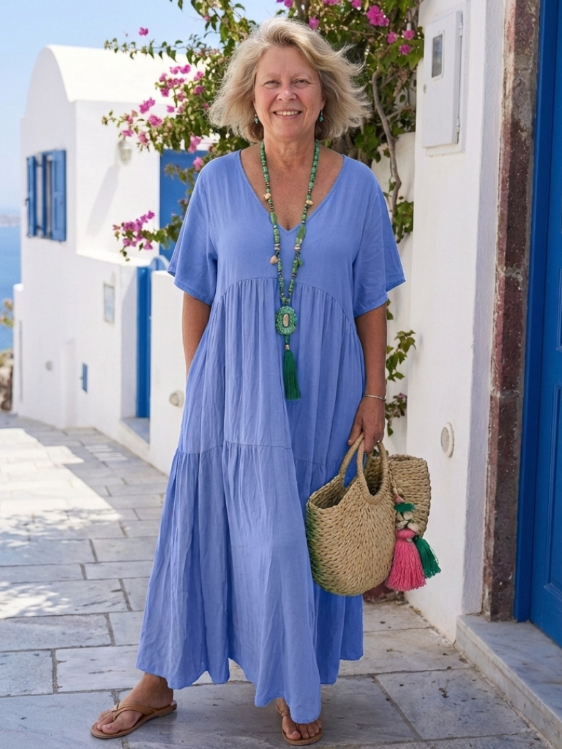Front view of a relaxed maxi dress displayed on a vacation setting background.