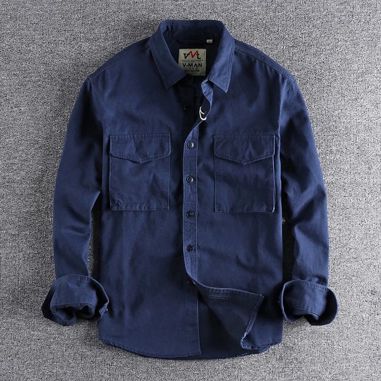 A long sleeve button-down utility shirt with dual chest pockets on a plain background.