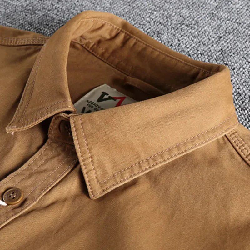 A structured button-front shirt with two chest pockets on a plain background.