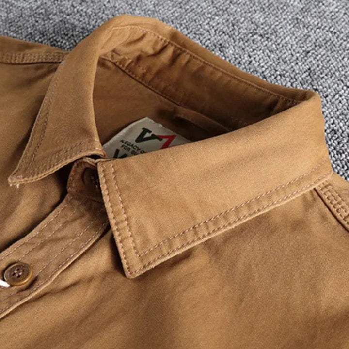A structured button-front shirt with two chest pockets on a plain background.