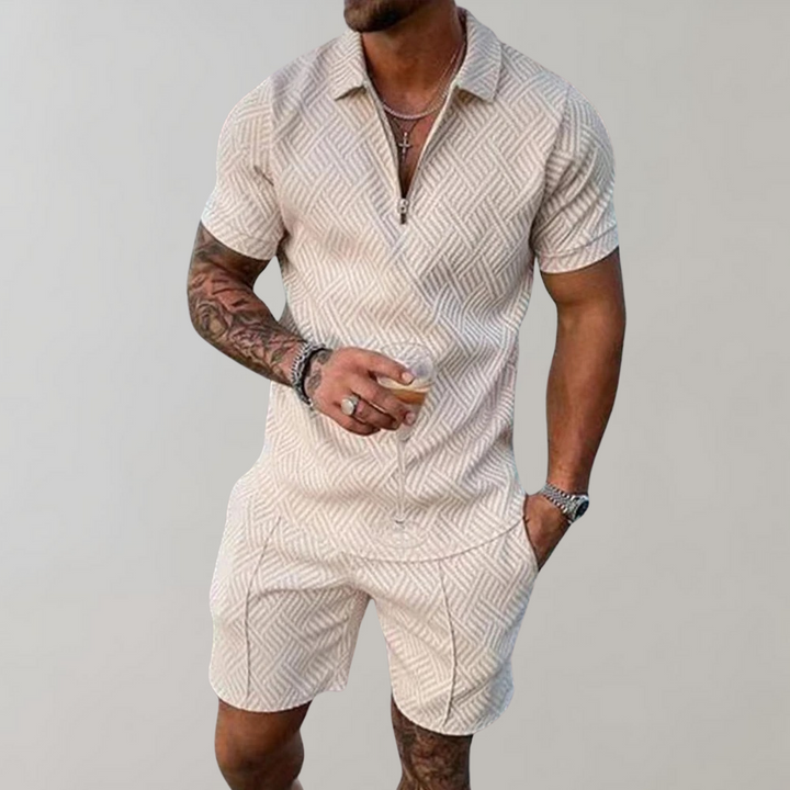  Male model showcasing a casual matching top and shorts outfit on a plain background.