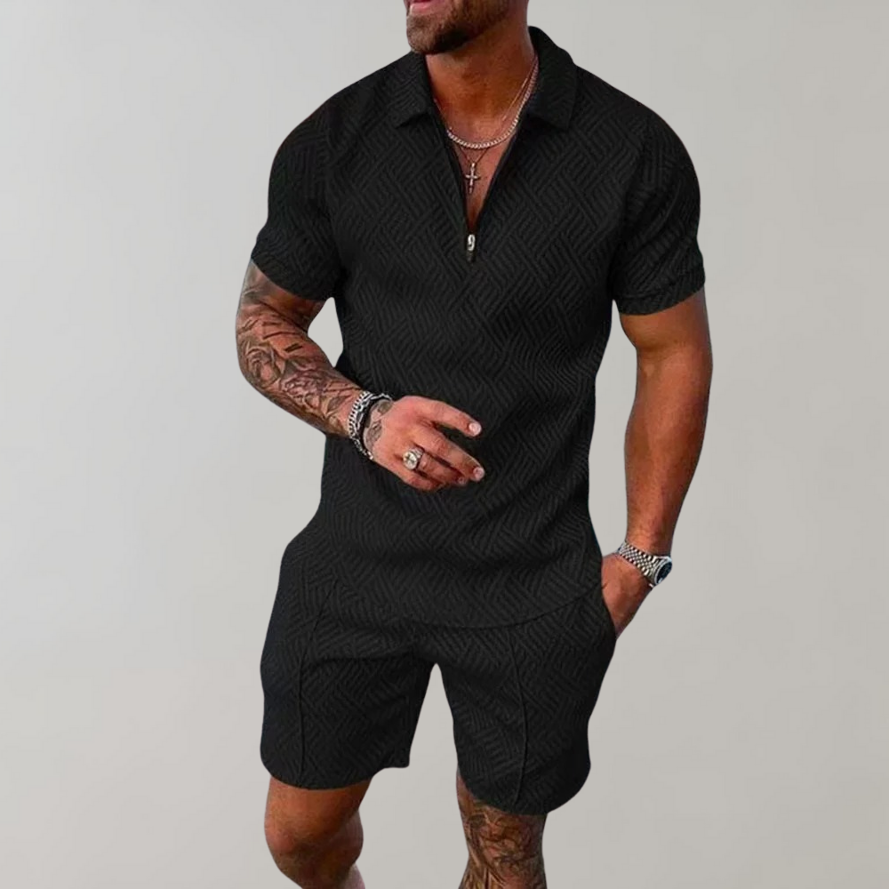 Male model wearing a zip-front short-sleeve top with matching shorts on a plain background.