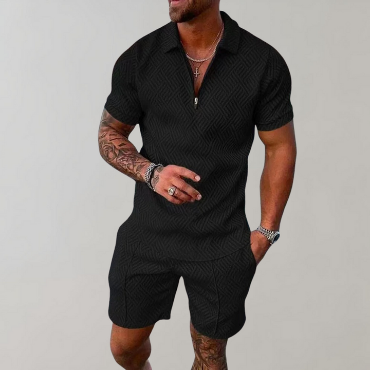 Male model wearing a zip-front short-sleeve top with matching shorts on a plain background.