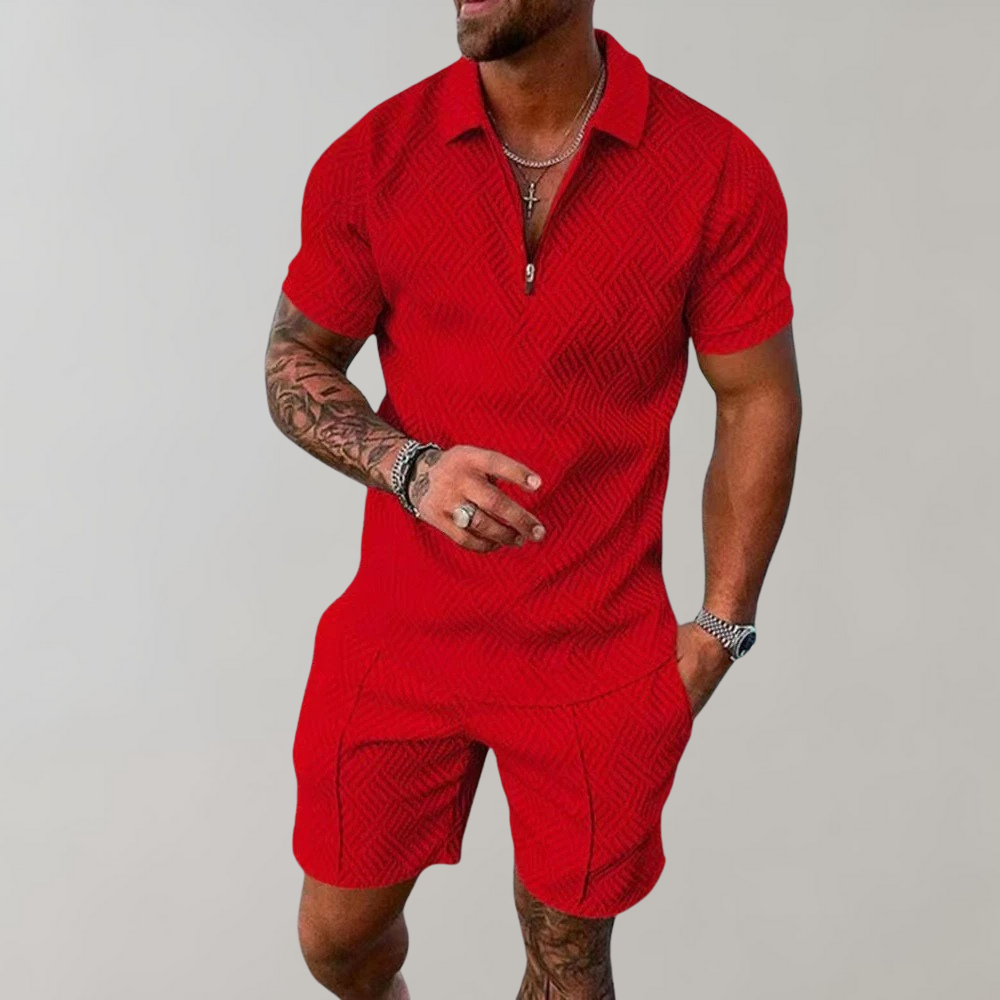 Male model displaying a relaxed two-piece outfit with matching shorts and top on a plain background.