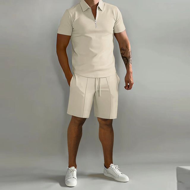 Male model wearing a short-sleeve half-zip polo top with matching drawstring shorts on a plain background.