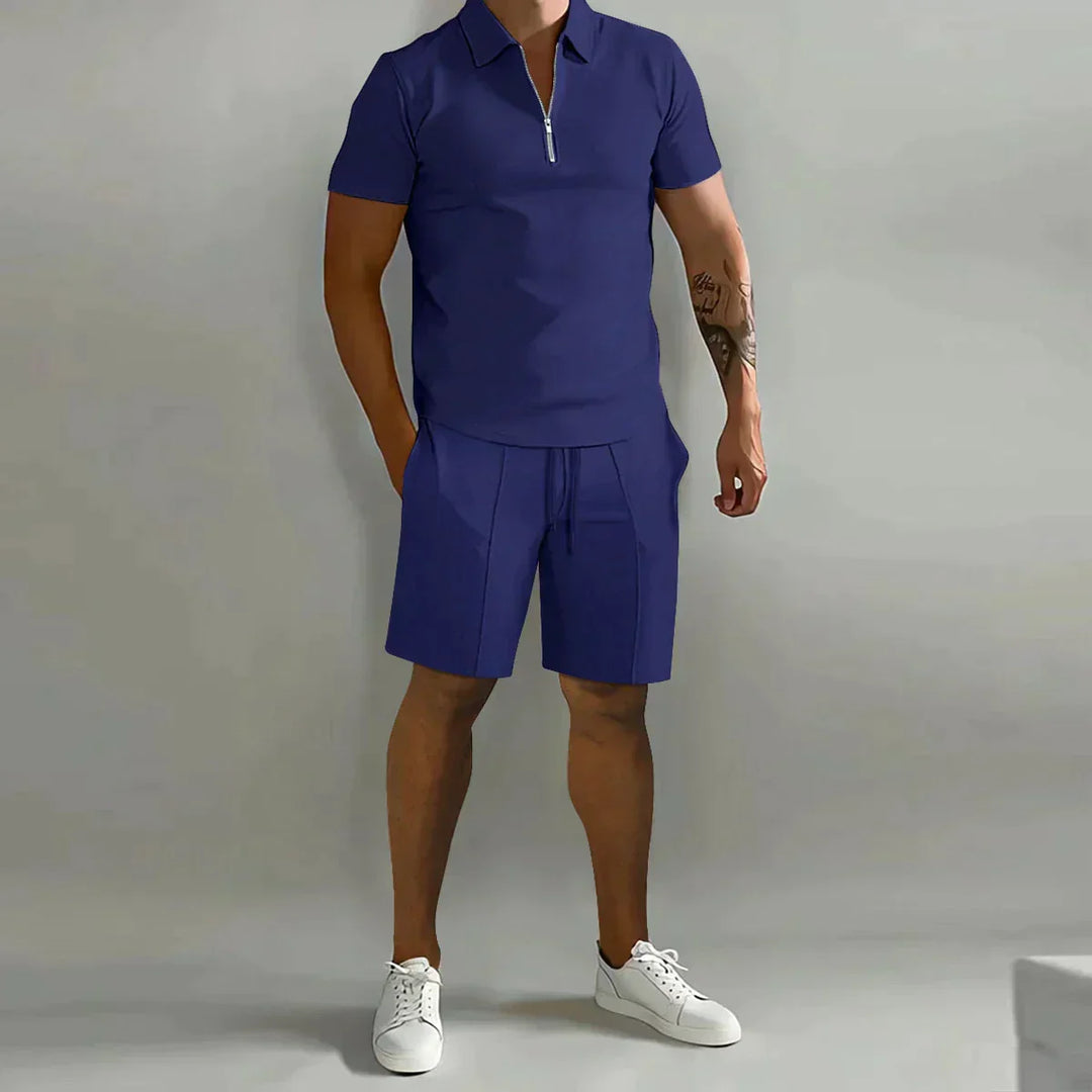  Male model in a casual matching short-sleeve top and shorts set against a plain background.