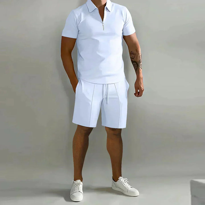  Male model displaying a relaxed two-piece outfit with polo styling on a plain background.
