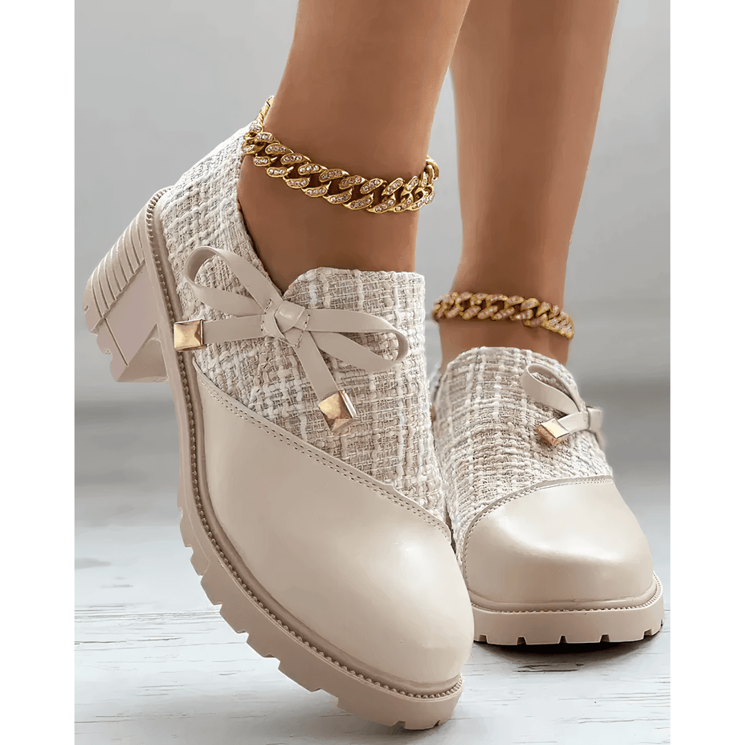 Angled stance foot model highlighting balanced heel loafers plain background