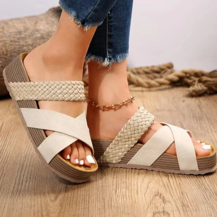  Model showcasing slip-on platform sandals with a bold sole on a plain background.