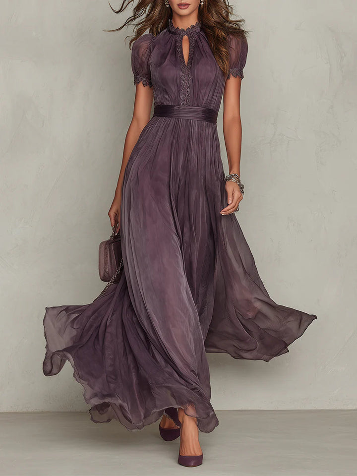 Female model wearing a long purple formal dress against a plain background.
