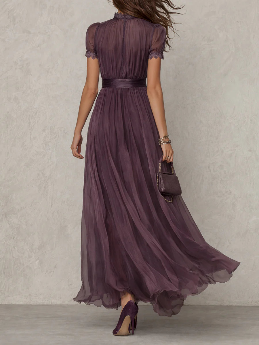 Long sleeve purple formal dress displayed on a female model with plain backdrop, back view