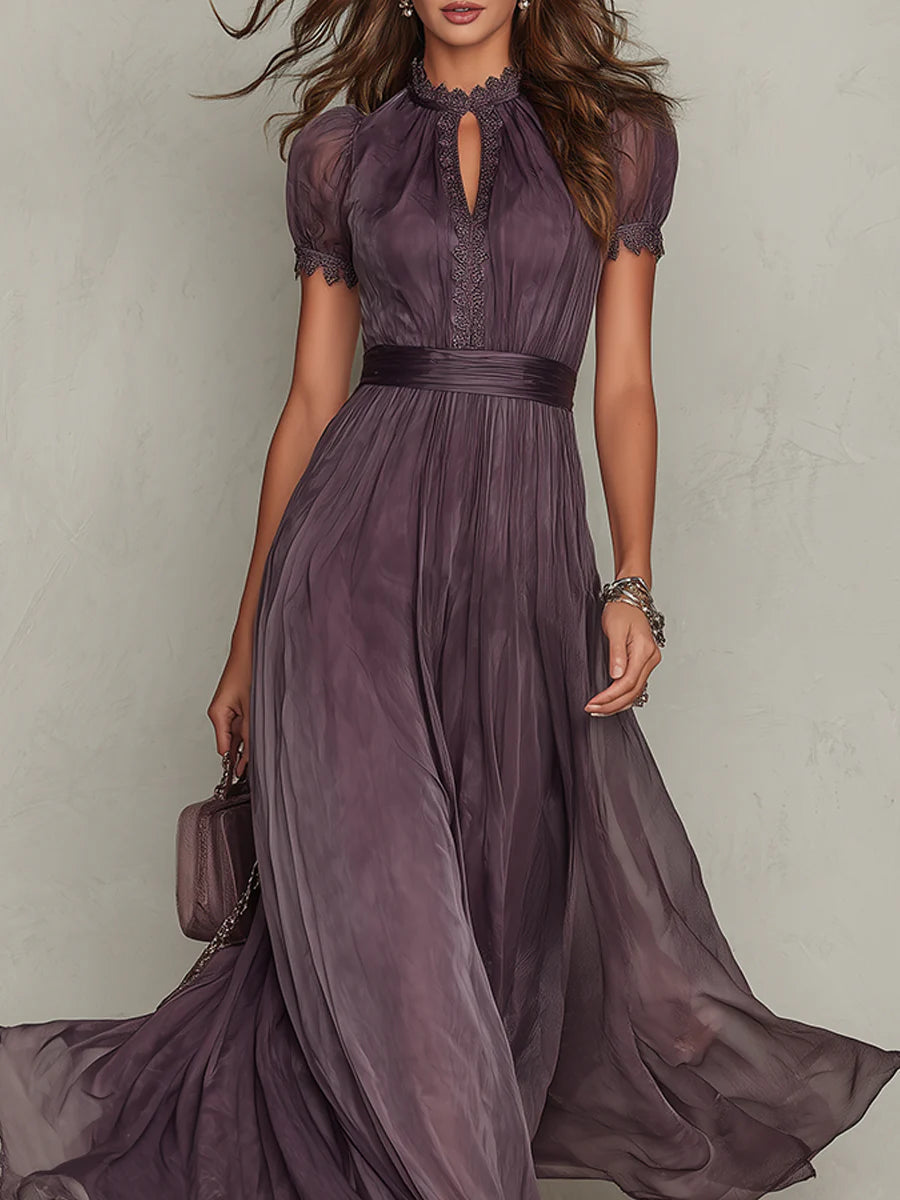 Woman standing in a flowing purple dress for formal occasions on a plain background.