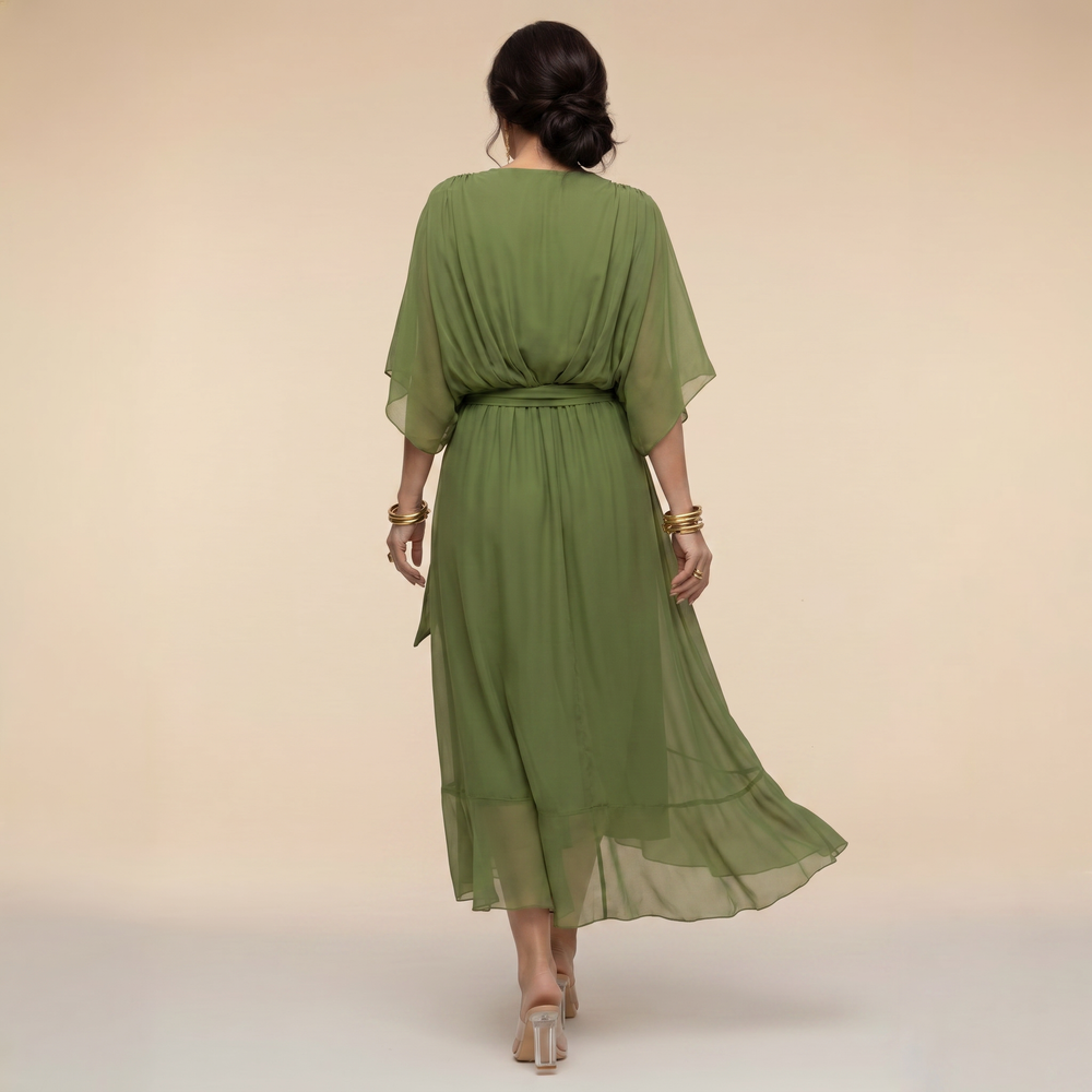 Woman wearing a V-neck wrap midi dress against a plain background.