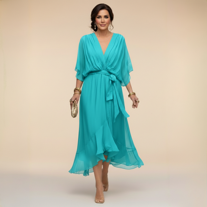 Female wearing a polished V-neck midi dress against a plain background.