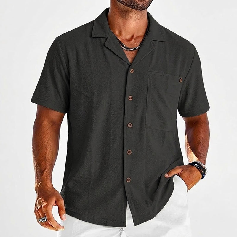  Male model in a lightweight button front shirt on a plain background.