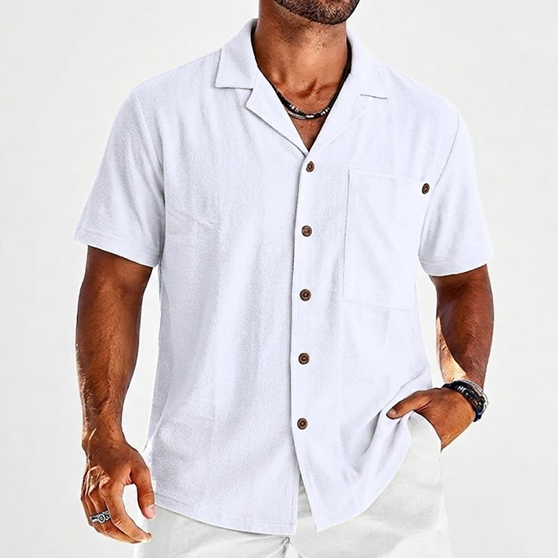  Male model wearing a casual open collar shirt with chest pocket detail.