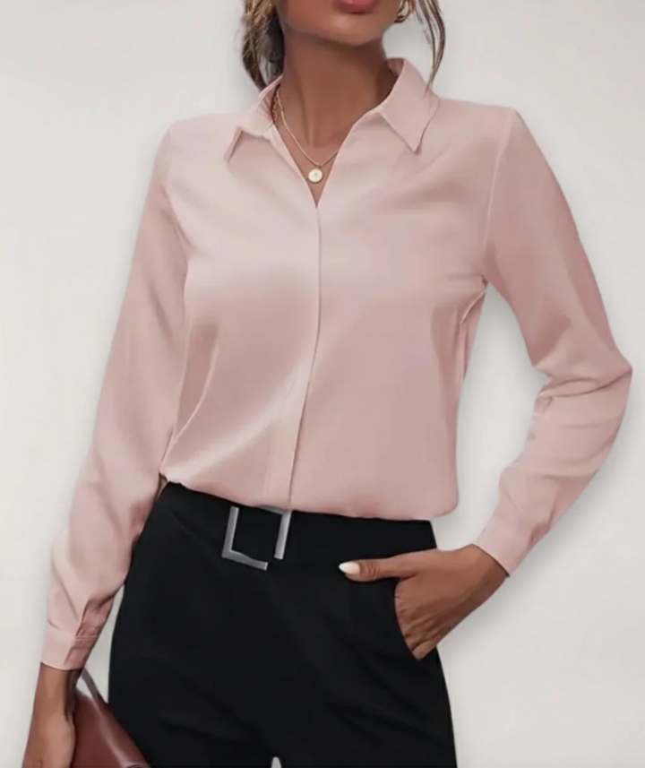 Female in elegant office blouse displayed on a plain background with refined tailored styling