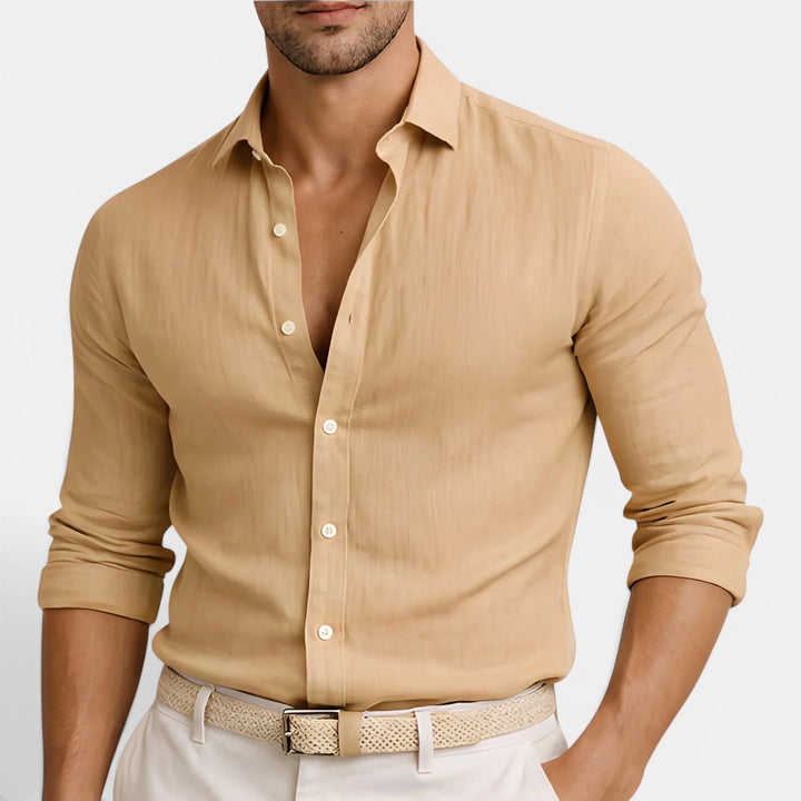  Man showcasing a versatile long sleeve shirt against a plain background.