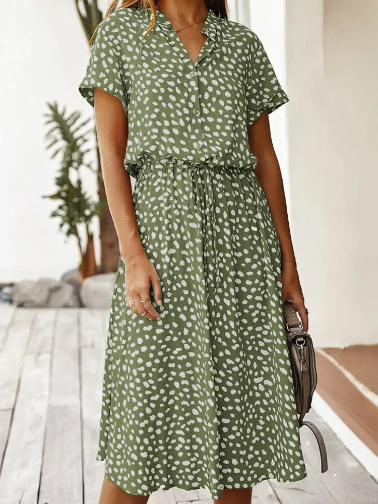 Green casual midi dress styled with neutral handbag