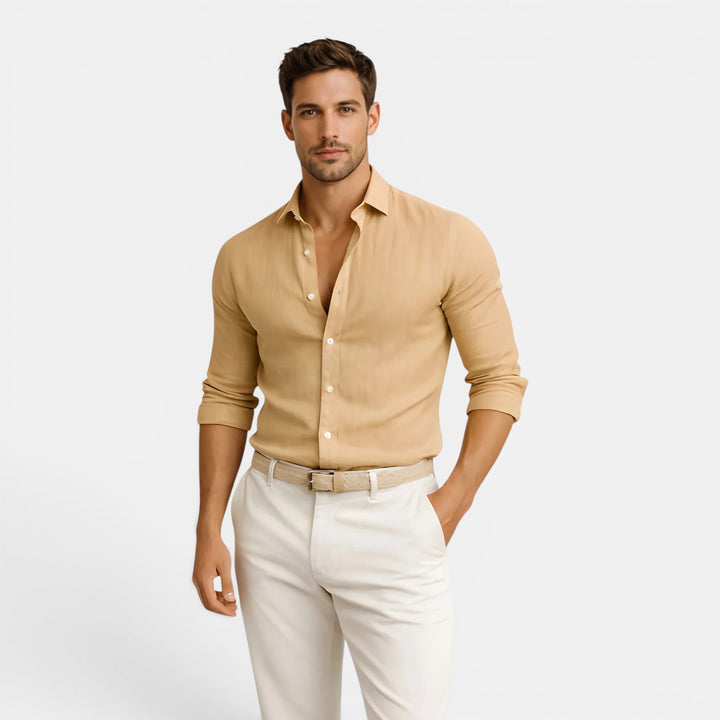  Man dressed in a refined casual shirt on a plain background.