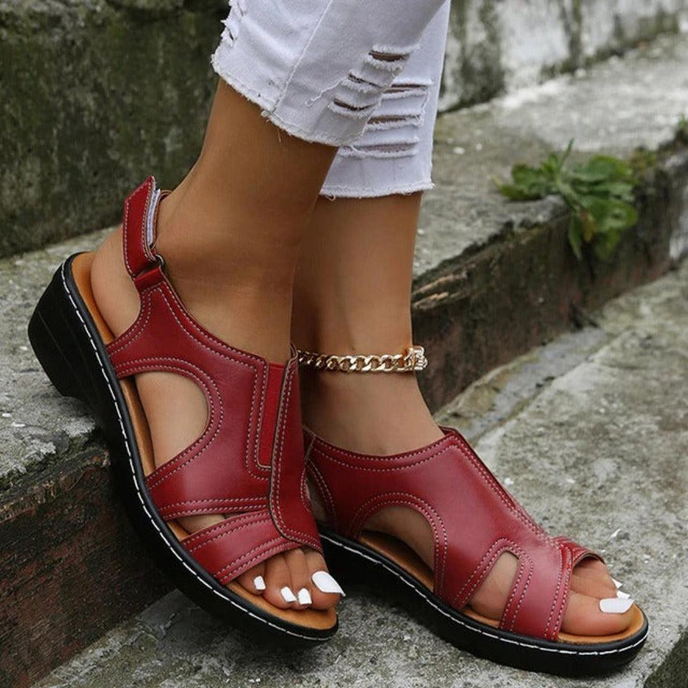 Close up toes wearing sandals on plain cement background scene