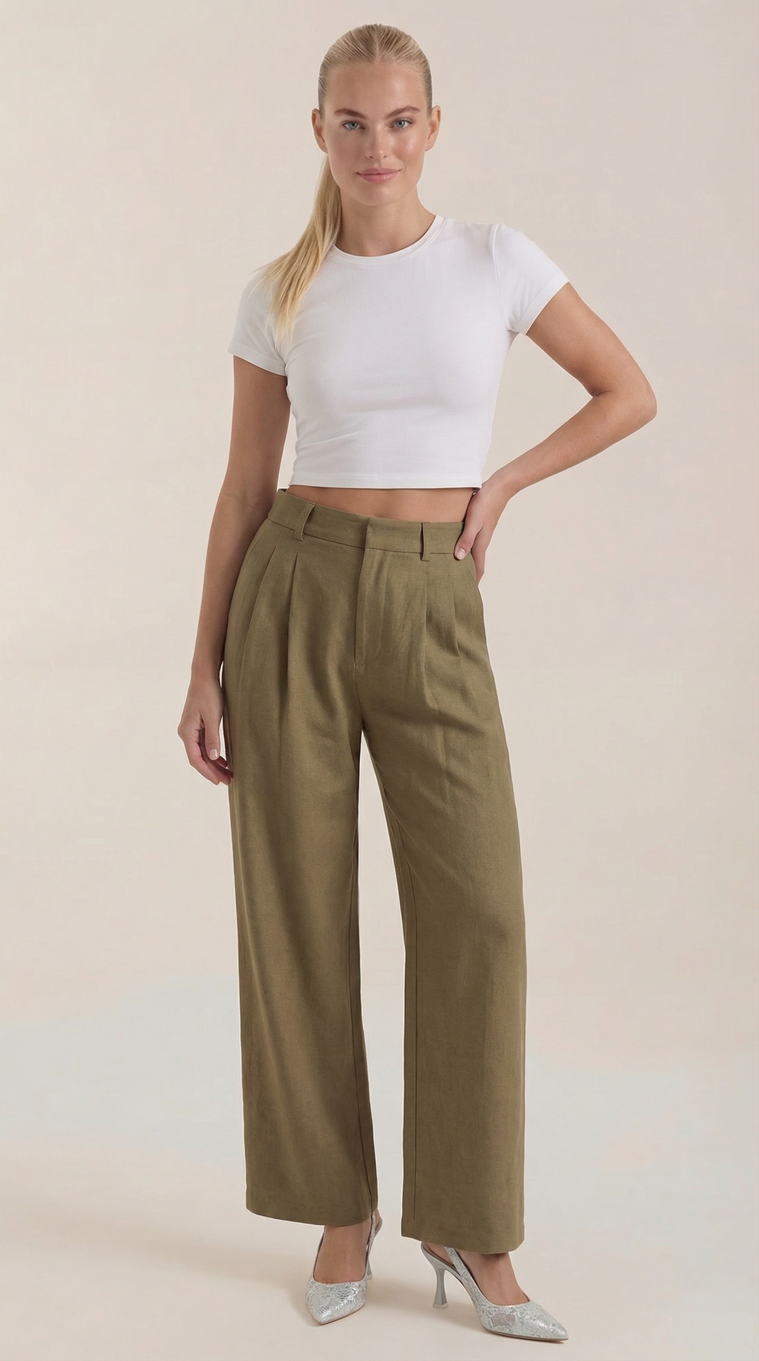 Female model showing wide-leg pants with relaxed fit plain background.